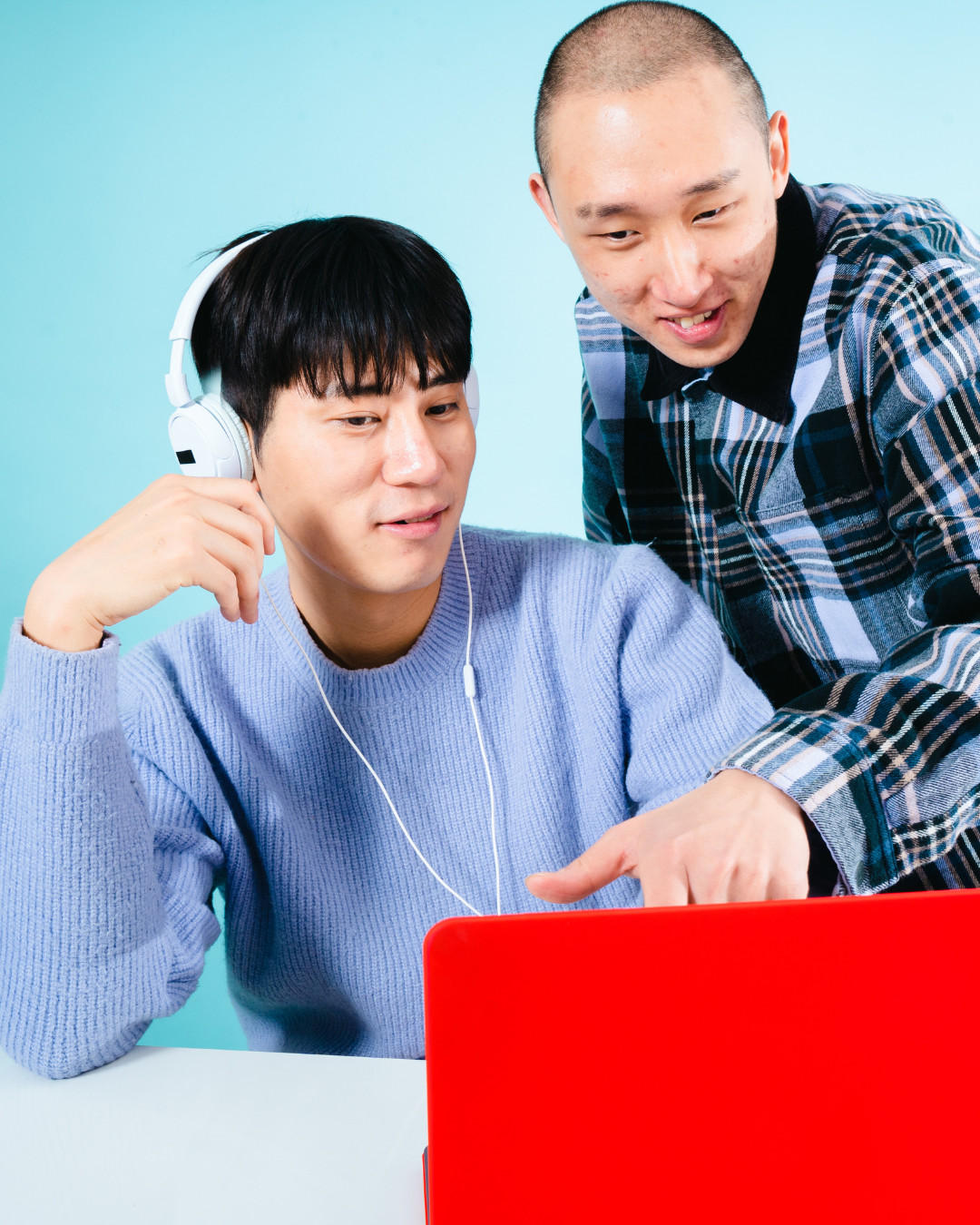 Two students collaborating on a laptop