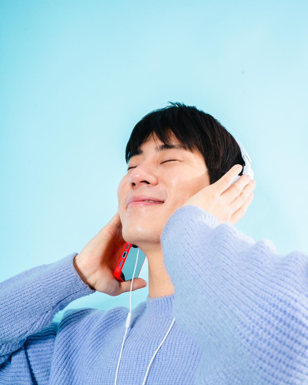 Student listening to music with eyes closed